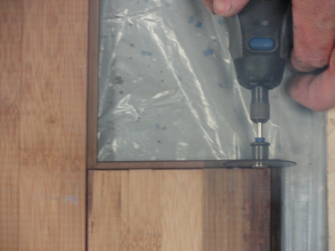 dremel tool measuring and cutting plywood for DIY sliding barn door laminate wood flooring
