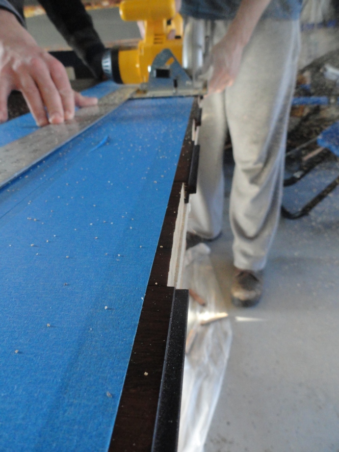 trimming and sanding DIY sliding wood barn door laminate floor